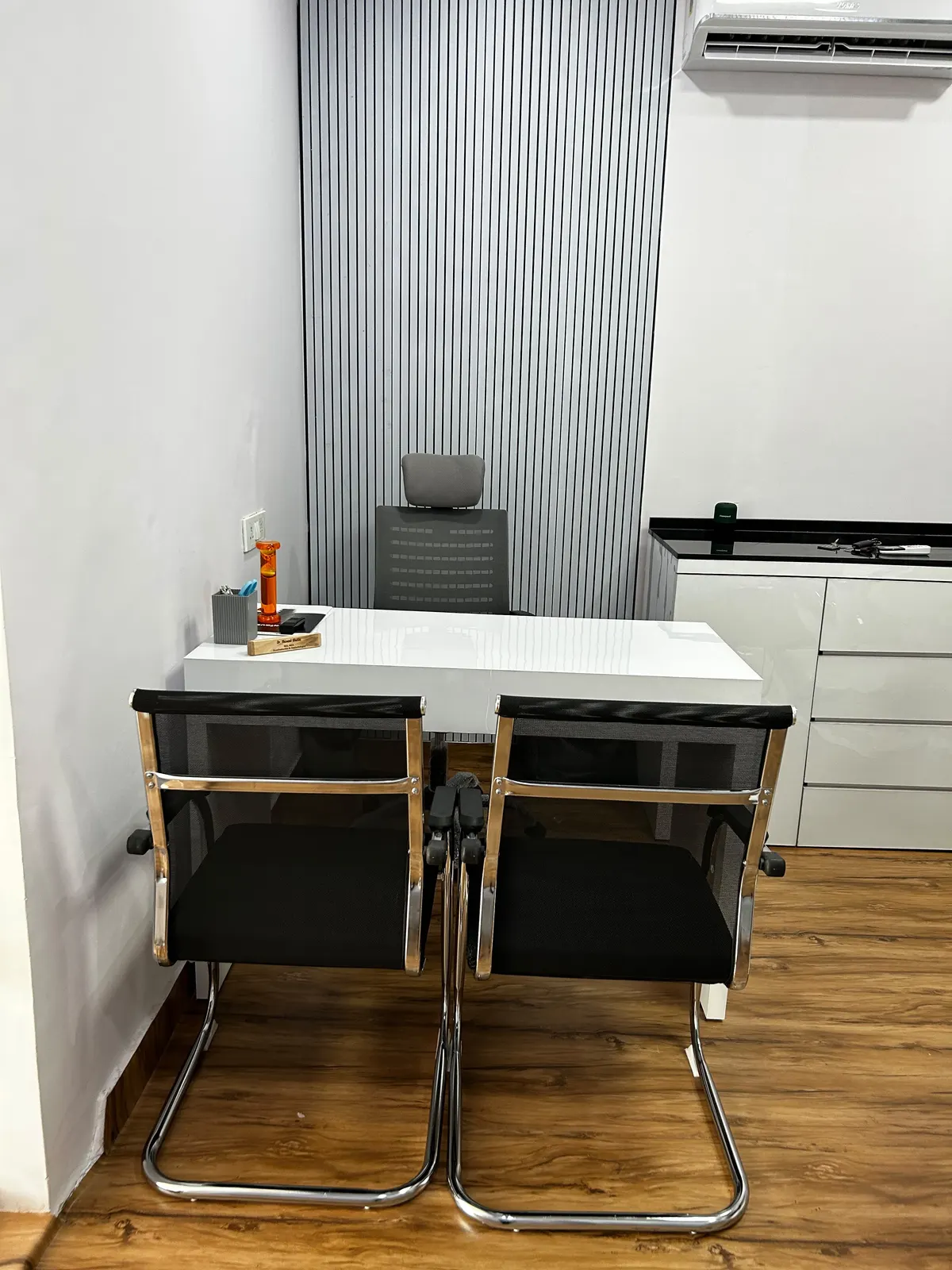 Private consultation room with the director's desk and seating for two patients or family members
